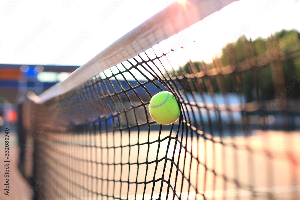 Bright greenish yellow tennis ball hitting the net. Stock Photo | Adobe  Stock