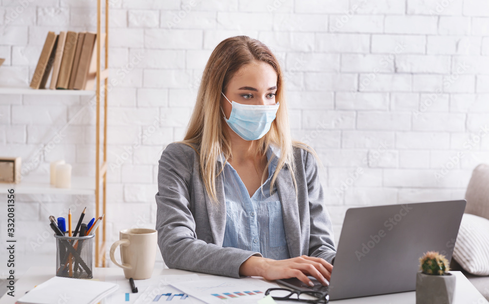 Remote work during epidemic. Woman works in protective mask - obrazy, fototapety, plakaty 