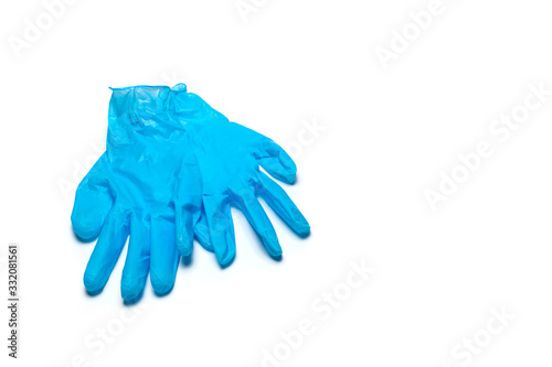 A pair of blue medical gloves on a white isolated background. Copy space
