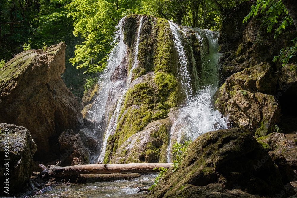 A beautiful waterfall deep in the forest, steep mountain adventure in the rainforest.