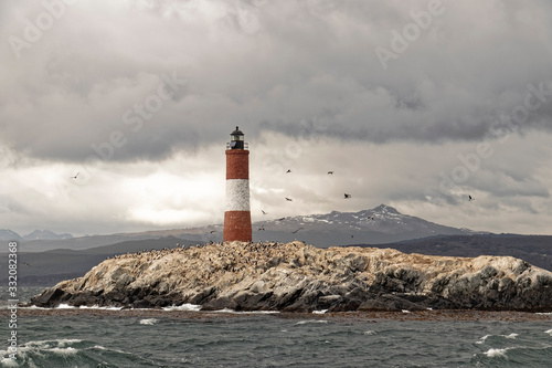 Argentina, Patagonia – Island with a lighthouse on the background of mountains.
