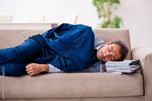 Young male employee working from house