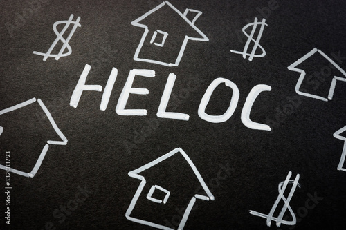 HELOC home equity line of credit loan and homes on the black sheet.