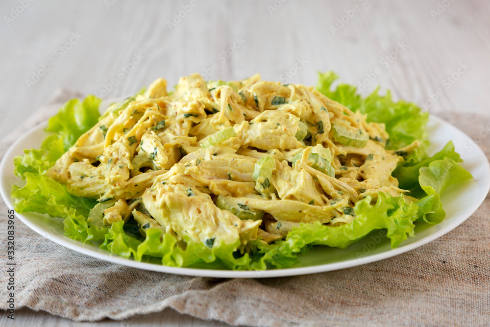 Homemade Coronation Chicken Salad on a white plate, side view. Close-up.