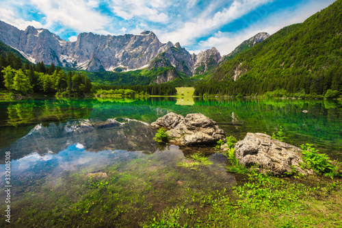Lake Fusine with high rocky Mangart mountains in background, Italy