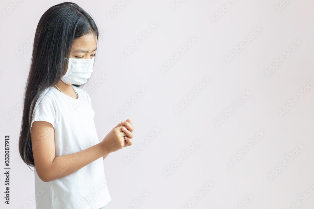 The child is rubbing her hands with alcohol gel on her palm to clean. The child is rubbing her hands with alcohol gel on her palm to clean.