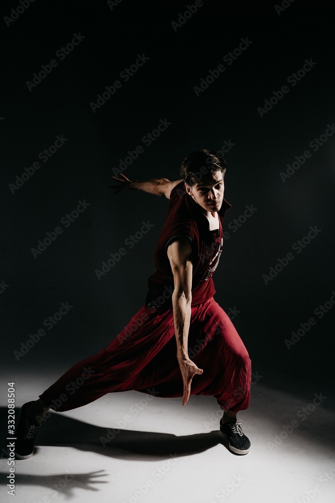 A dancer in red slacks and a t- shirt