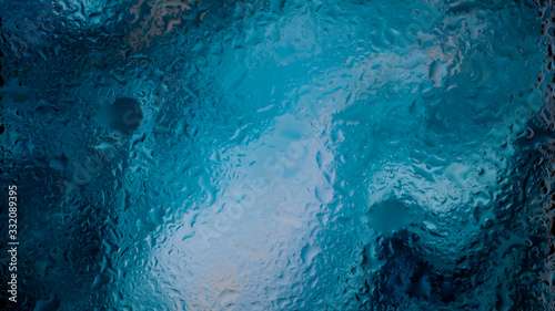 Abstract blue wallpaper. Drops of water on a window pane