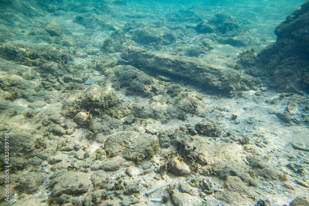 Ocean seabed with stones and sand.