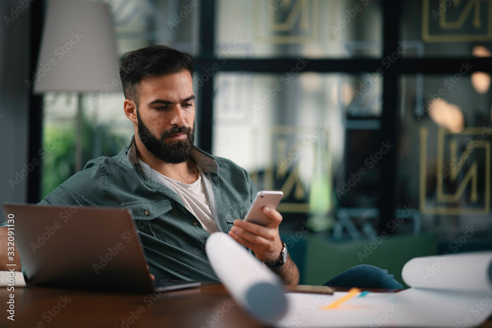 Businessman in office. Handsome man using phone at work. Businessman in office. Handsome man using phone at work.