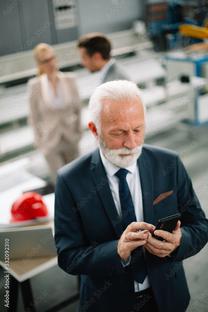 Handsome businessman using phone. Businessman talking to smart phone. Handsome businessman using phone. Businessman talking to smart phone.