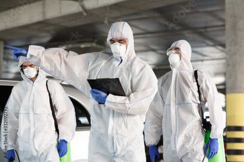 Cuadro en lienzo Men in virus protective suits enclosing the quarantine zone
