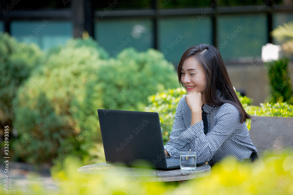 Smiling businesswoman working on laptop in cafe Smiling businesswoman working on laptop in cafe