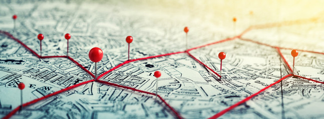 Routes with red pins on a city map. Concept on the  adventure, discovery, navigation, communication, logistics, geography, transport and travel topics.
