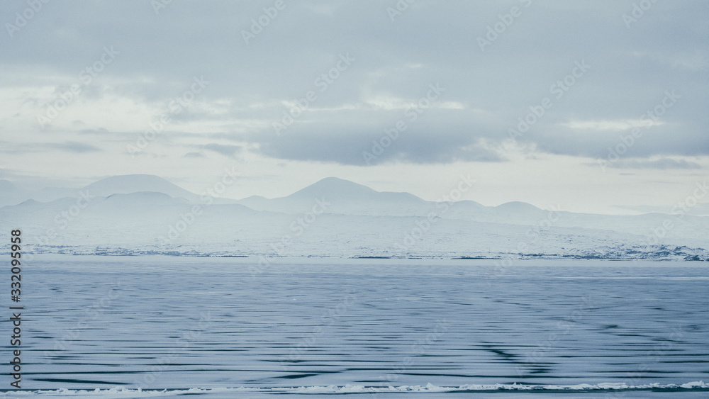 clearly white Background from The frozen Lake Sevan in Armenia, like a scene from film clearly white Background from The frozen Lake Sevan in Armenia, like a scene from film