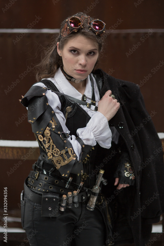 Naklejka premium Beautiful girl model in the steampunk style on the street. Fashionable style
