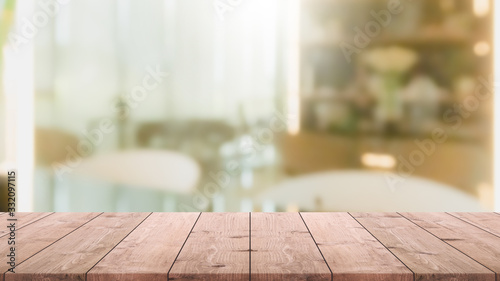 Empty wood table top and blur glass window interior restaurant banner mock up abstract background - can used for display or montage your products. © bunditinay