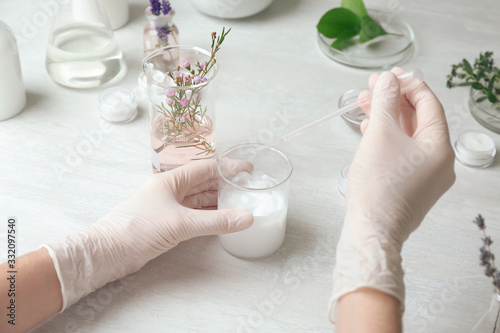 Scientist developing cosmetic product in laboratory, closeup