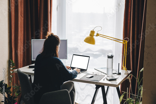 woman working on laptop at home. telework
