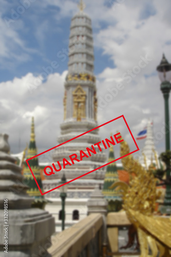 Text warning about quarantine against the background of Buddhist architecture in Pattaya, Thailand.