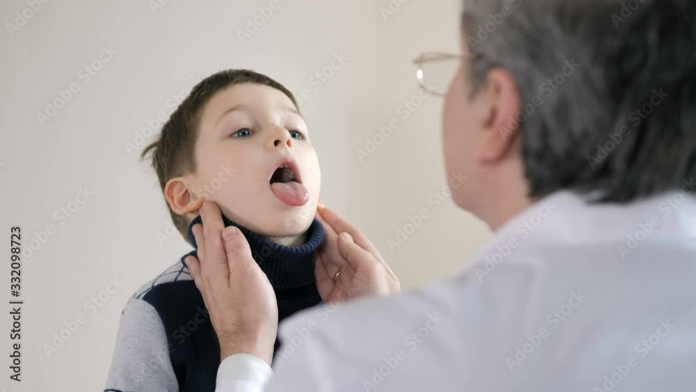 Children's doctor examining little boy in hospital Children's doctor examining little boy in hospital