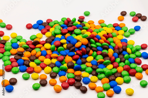 Mountain of colorful candies on a white background