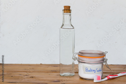 baking soda and vinegar on wooden background © Maderla
