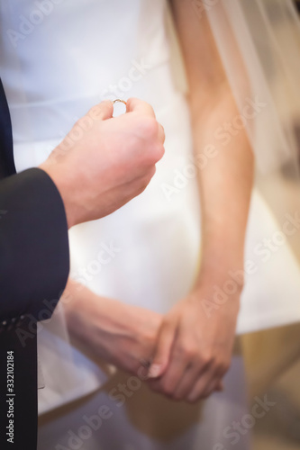 Moment of the exchange of rings during a religious wedding
