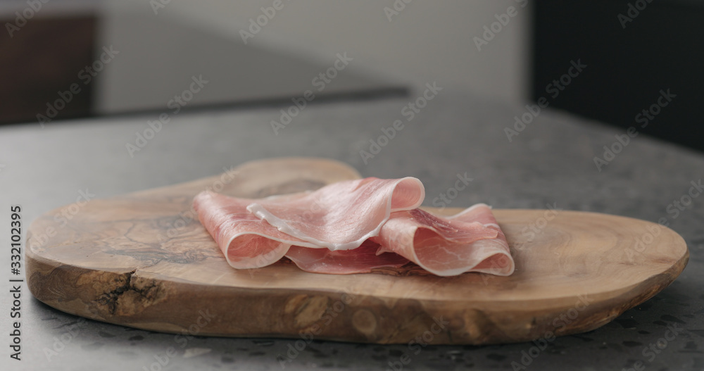 prosciutto ham on wood board