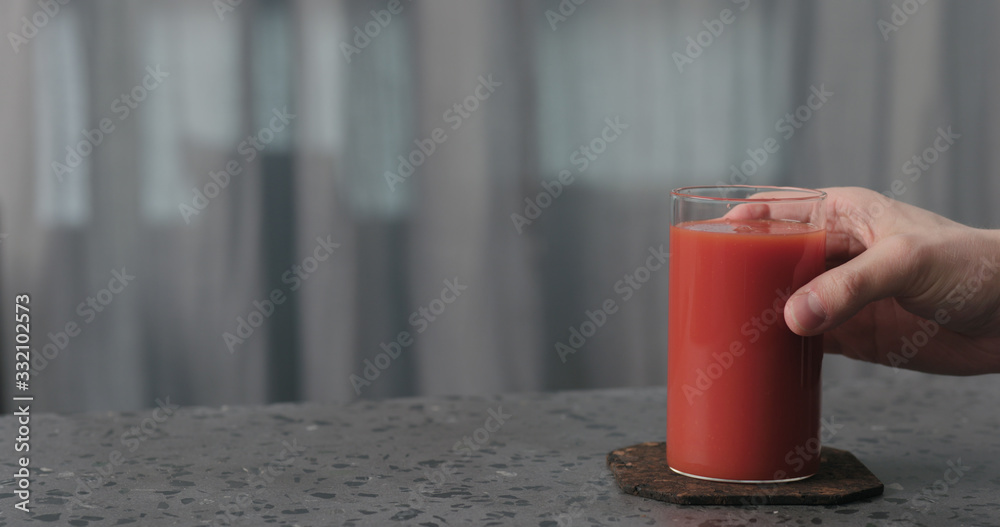 man hand take tomato juice glass from concrete surface with copy space man hand take tomato juice glass from concrete surface with copy space