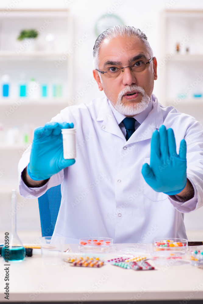 Old male chemist working in the lab Old male chemist working in the lab