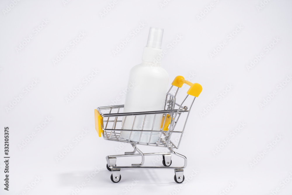 Consumer buying panic about coronavirus covid-19 concept. Sanitizer antiseptic gel in shopping trolley isolated. People are stocking up essentials for home quarantine.