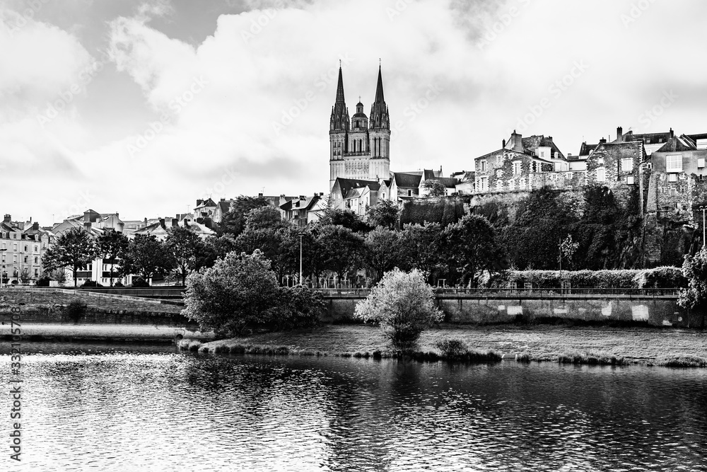 Fototapeta premium Panorama of the city of Angers, France with Saint Maurice Cathedral of Angers and the old town on the banks of the river Maine in black and white