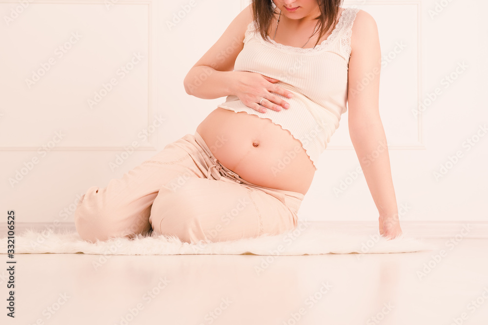 Pregnant woman resting at home, toned image