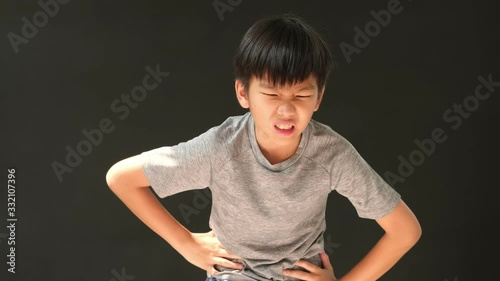 4k young Asian boy has a stomachache