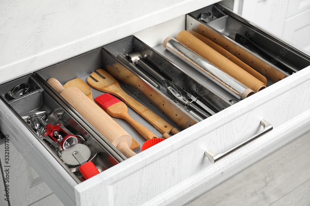 Different utensils in open desk drawer indoors Different utensils in open desk drawer indoors