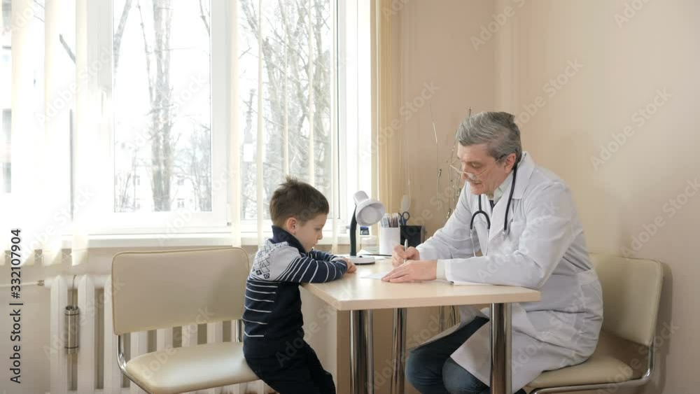 Children's doctor examining little boy in hospital Children's doctor examining little boy in hospital