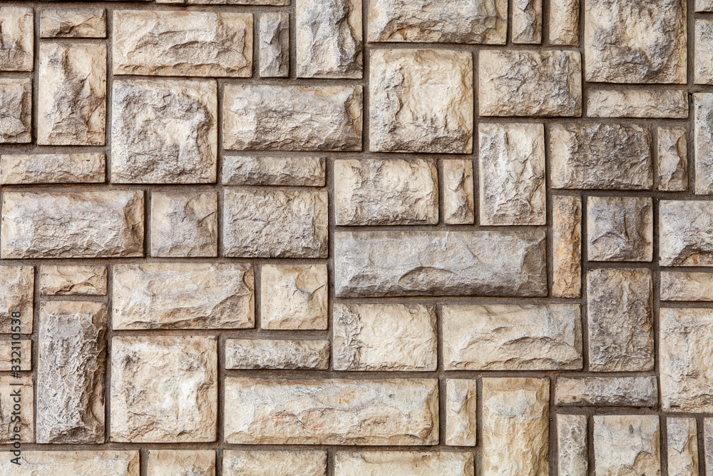 old grey stone wall made of stone blocks
