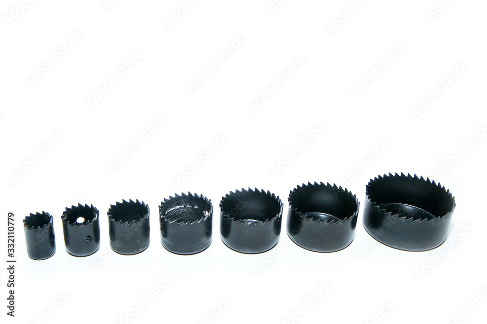 The detail of a special drill used for making the big round holes isolated in a white background. The detail of a special drill used for making the big round holes isolated in a white background.