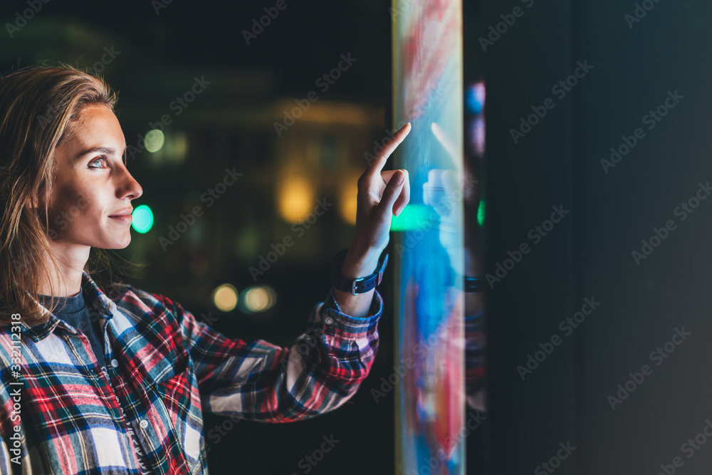 girl pointing finger to blank monitor display, hipster touch screen technology on light night, click media lcd device, mockup screen information gadget - obrazy, fototapety, plakaty 