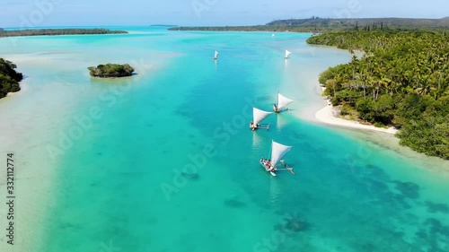 The bay of Upi in New Caledonia with the typical boats of the Kanak people. Isle of Pines. photo
