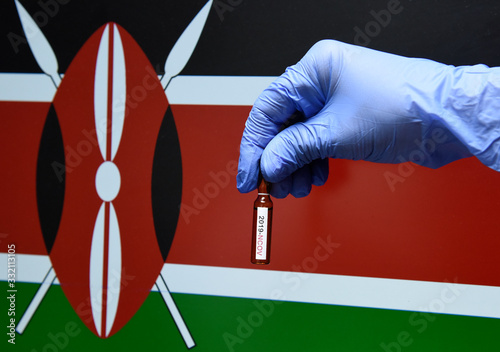 Corona virus or Covid-19 in Kenya , sample blood tube in hand with Kenya flag on background