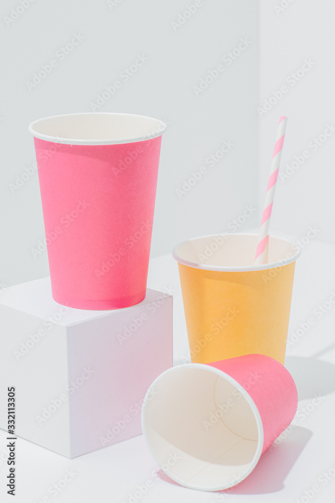 Vertical composition of bright paper disposable, compostable, recyclable cups Vertical composition of bright paper disposable, compostable, recyclable cups