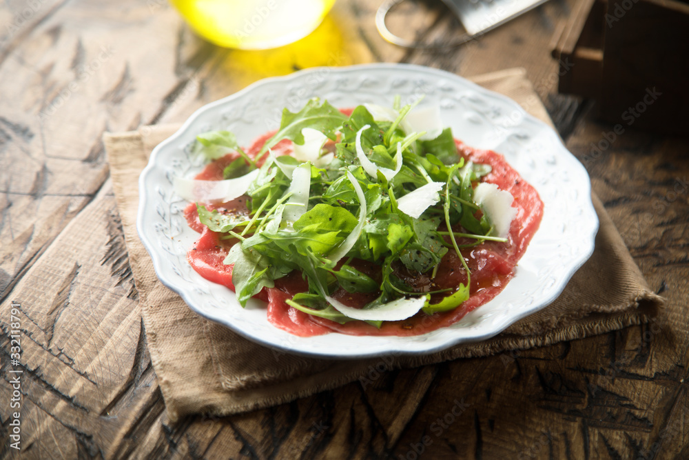 Beef carpaccio with arugula and Parmesan cheese Beef carpaccio with arugula and Parmesan cheese