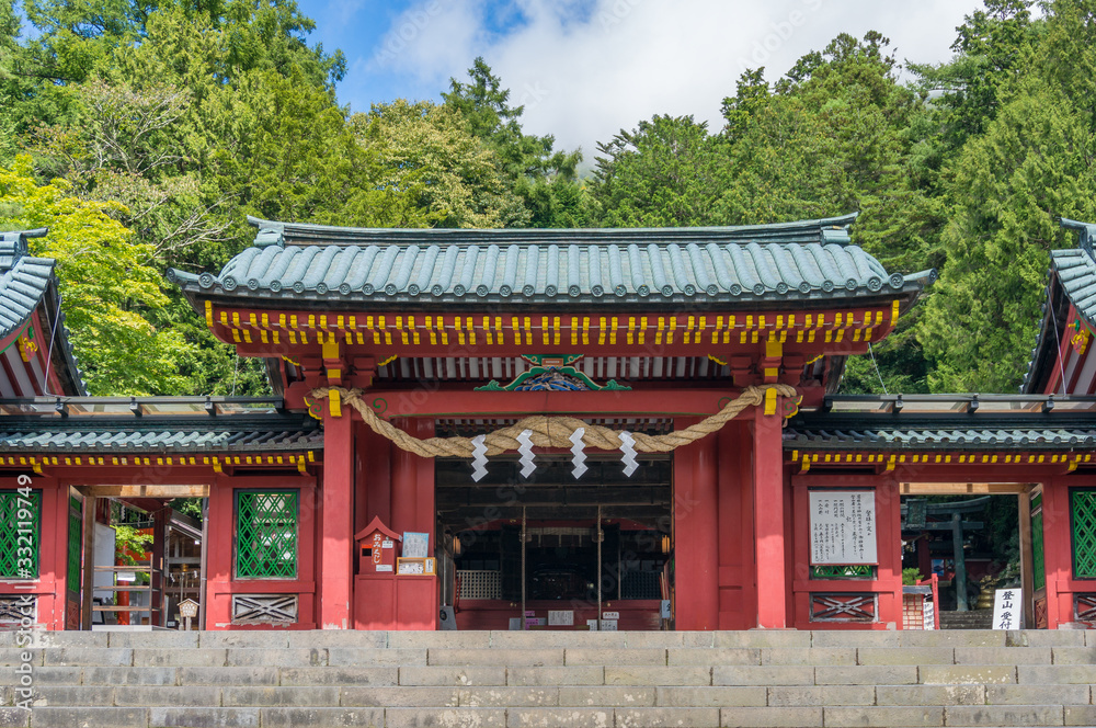 Entrance to Japanese shrine with red decorated gates Entrance to Japanese shrine with red decorated gates