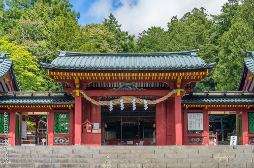 Entrance to Japanese shrine with red decorated gates