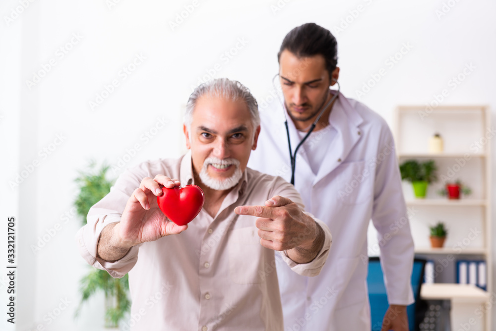Old man visiting young male doctor cardiologist Old man visiting young male doctor cardiologist