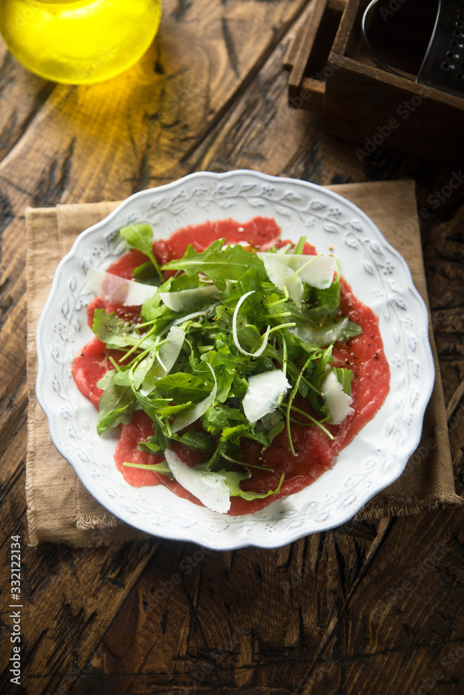Beef carpaccio with arugula and Parmesan cheese Beef carpaccio with arugula and Parmesan cheese