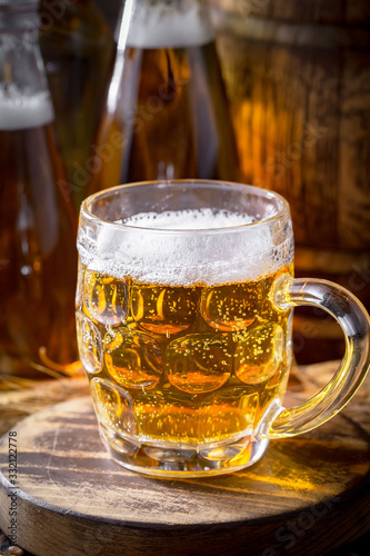 Light beer in a glass on a table in composition with accessories on an old background