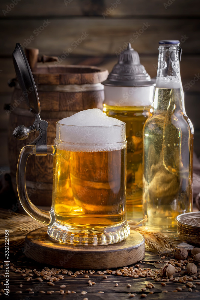 Light beer in a glass on a table in composition with accessories on an old background Light beer in a glass on a table in composition with accessories on an old background